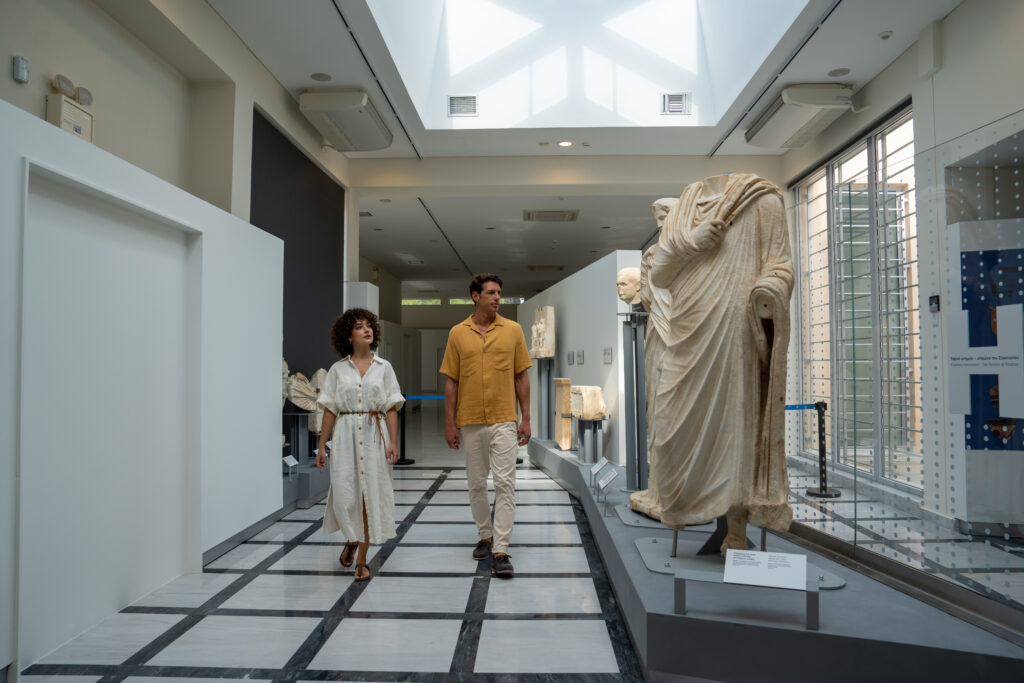 Walking through exhibits and ancient scultures at the Archaeological Museum of Polygyros