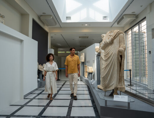Walking through exhibits and ancient scultures at the Archaeological Museum of Polygyros