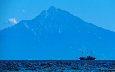 A boat cruising and on the background we see the majestic Mount Athos