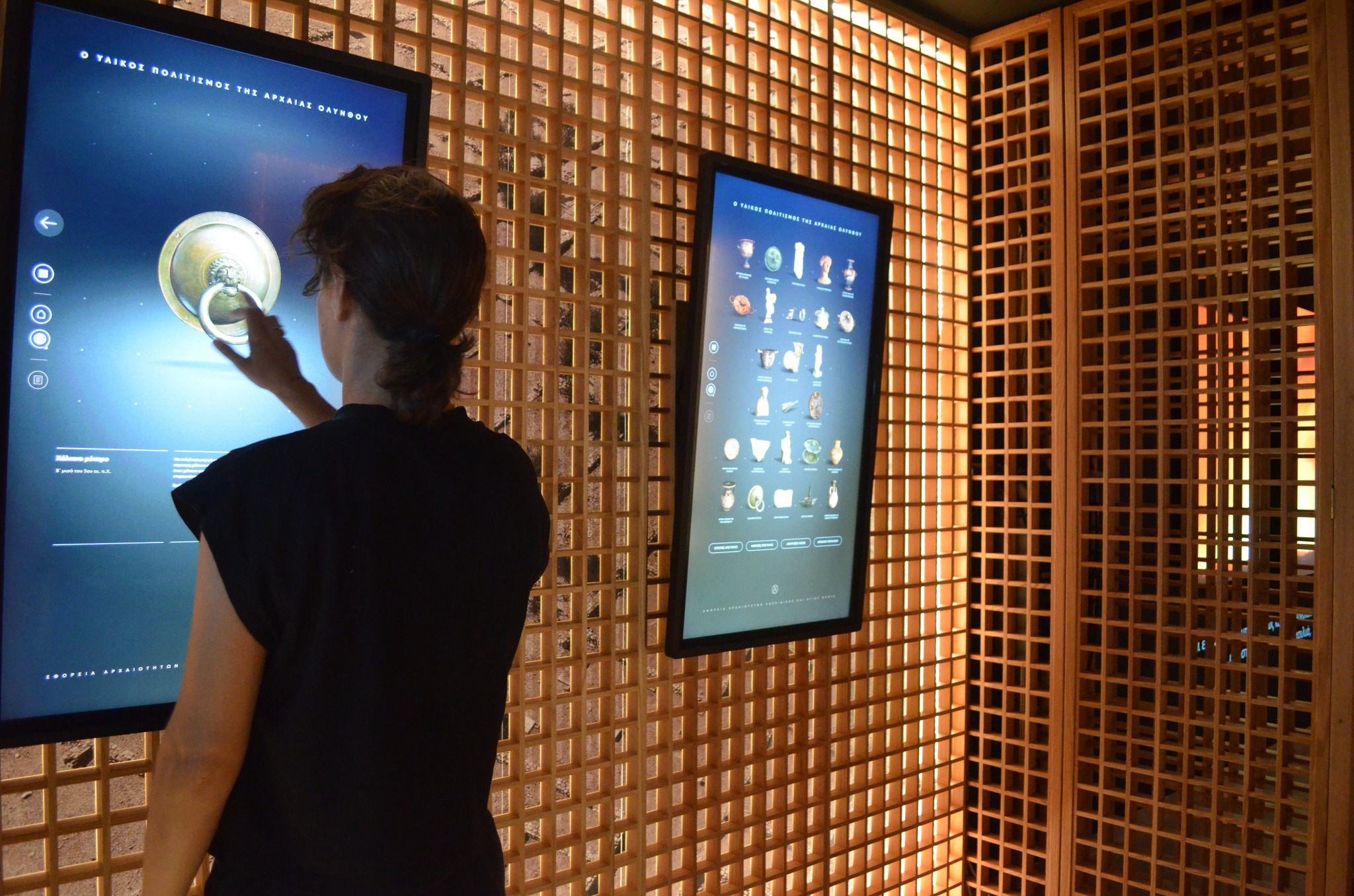 A girl using the touch screen in the interactive museum